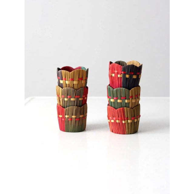 Bright and festive, this is a set of six vintage straw drink holders. A mix of vibrant colors accentuate the woven cozies...