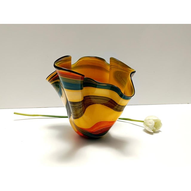 Made in Italy, 1980s. This is a Murano glass vase. It is a vintage piece, therefore it might show slight traces of use,...