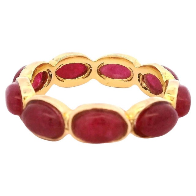 A refined and vibrant eternity band from Talia Jade, showcasing approximately 3 carats of deep pink-red cabochon rubies...