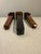 Striking set of three vintage decorative wooden obelisks in a two-tone black and warm brown finish. The trio features...