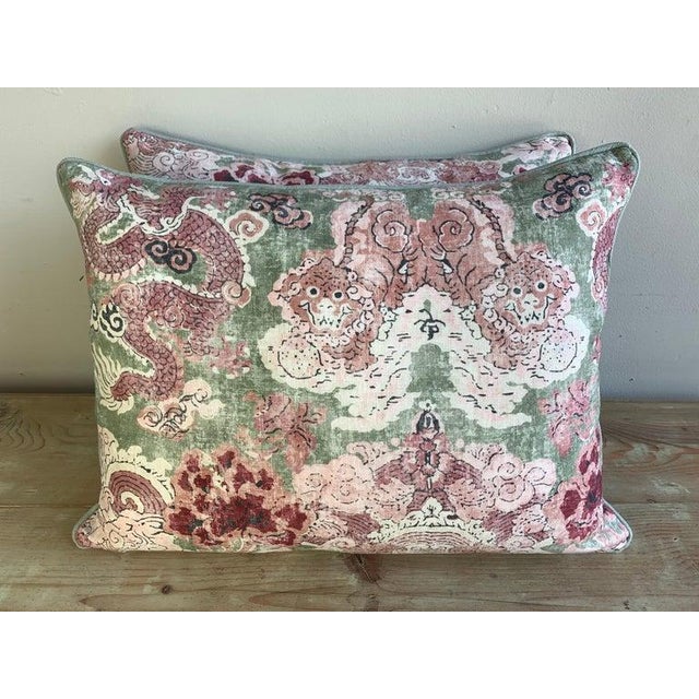 Pair of custom pillows made with a printed chinoiserie cotton front and a coordinating green back and self welt detail....