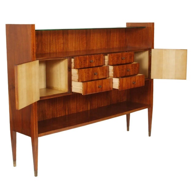 This mid-century Italian Rationalist credenza is veneered in rosewood and inlaid in maple and features an interior in...