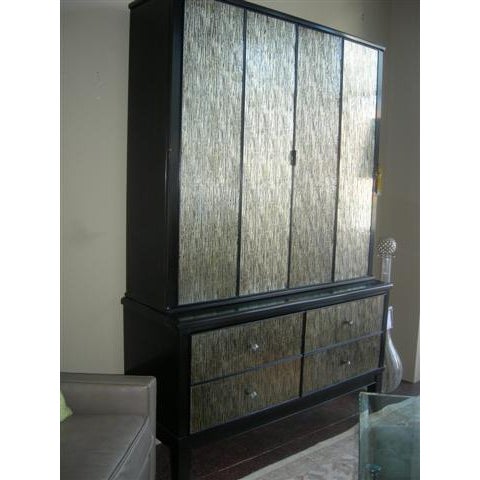 This is a striking 2 piece amoire piece with a dark espresso wood frame contrasting against shimmering, vertically...