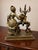 Intricately detailed vintage brass Rococo figural sculpture featuring a Victorian woman beside an ornate candelabra and...