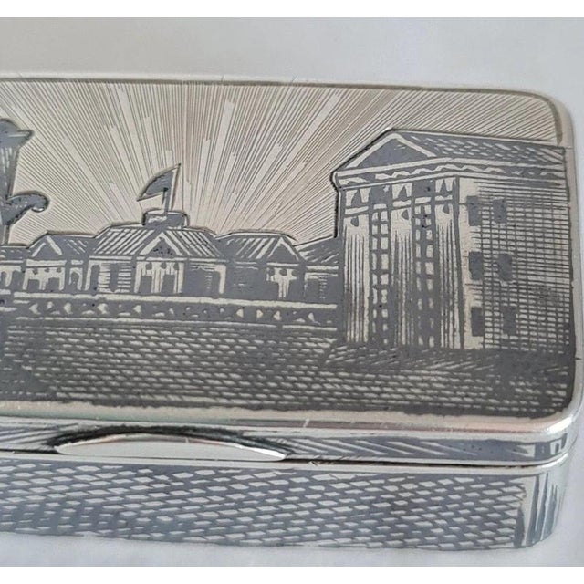 A fine antique Russian snuff box crafted in solid silver with a rich gilt finish and intricate niello decoration, dating...