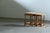 A set of three Danish oak nesting tables from the 1970s, designed to slide neatly beneath one another when not in use....