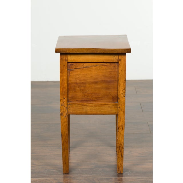 A petite French walnut side table from the late 19th century, with tambour door and tapering legs. Created in France at...