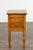 A petite French walnut side table from the late 19th century, with tambour door and tapering legs. Created in France at...