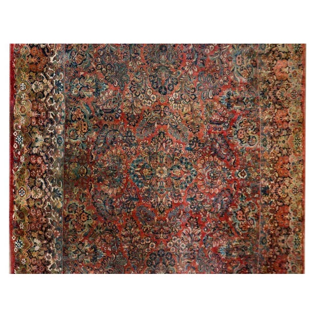 An incredible early 20th century Persian Sarouk rug with an incredible all-over floral cluster pattern woven in rich and...