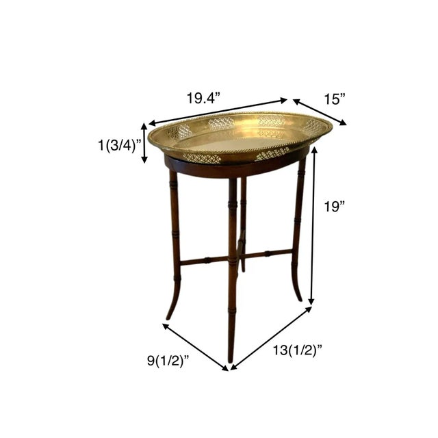 A Maitland-Smith side table in the coveted bamboo design, topped with a brass tray — designer pedigree with timeless...