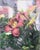 This oil on canvas artwork captures a vibrant display of blooming flowers, featuring rich hues of pink and hints of yellow...