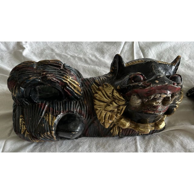 A pair of black and gold lions with some red accents. Considered to be auspicious and bringing good fortune.