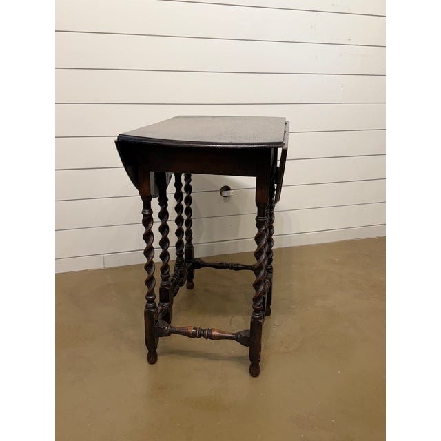 Gorgeous 19th Century antique English barley twist gate leg table! The table is made from oak and has a lovely dark finish...