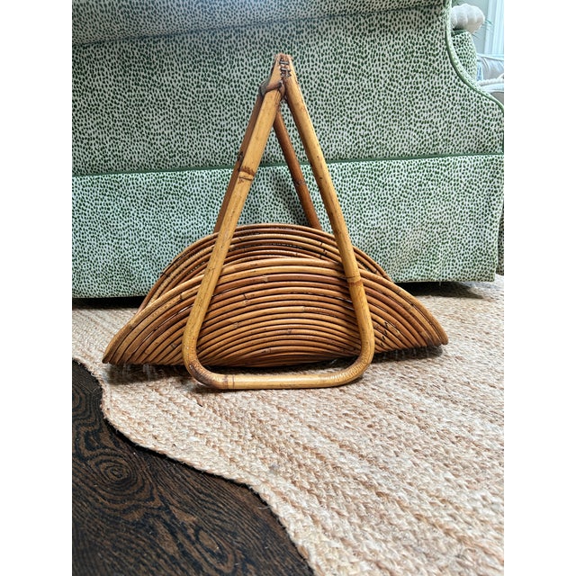 Striking vintage Italian pencil reed rattan magazine rack featuring a sculptural fan-shaped silhouette formed from...