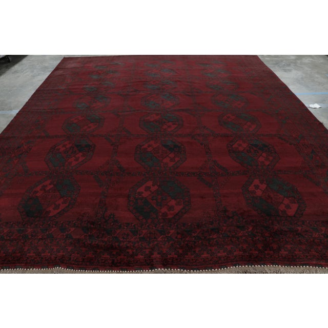 Originating from Afghanistan in 1950, hand-knotted in durable, high-quality wool, this more modern Afghan piece enjoys a...