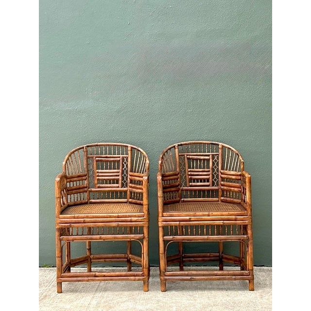 Bring timeless tropical elegance into your home with this striking pair of vintage Brighton Pavilion armchairs. Expertly...