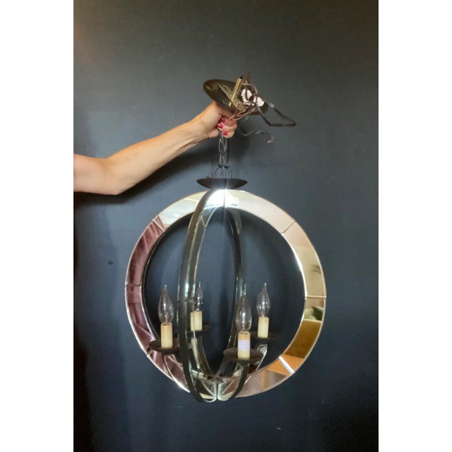 Chic Mid Century Modern Italian style mirrored circular pendant chandelier. Featuring two iron and antiqued faceted...