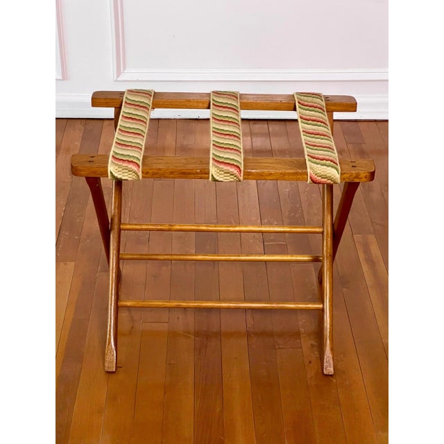Vintage 1940s wooden luggage rack with hand stitched embroidered straps. The frame features straight sculpted supports...