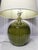 A matching pair of Tanner Kenzie ceramic table lamps from Arteriors Home with an organic gourd shape and avocado green...