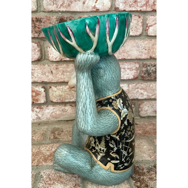 This pale green monkey holding a bowl over his head is attributed to Andrea by Sadek, The Chopsticks Collection, which was...