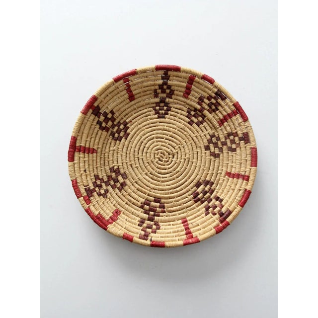 This is a vintage hand-woven basket. The southwestern bowl features a beautiful natural tone with red and purple accented...