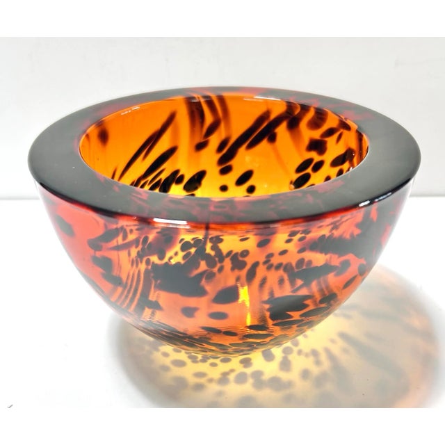 Heavy Italian crystal bowl with rich amber tortoiseshell-style mottling and a thick polished rim. Its sculptural form...