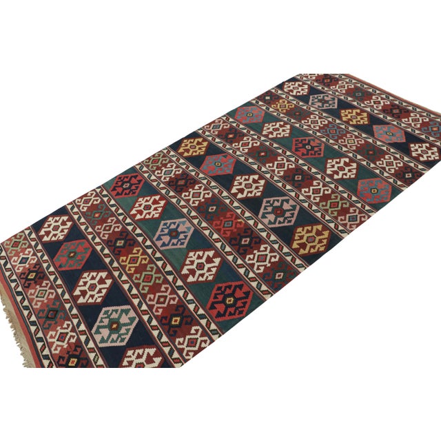 This vintage 7x15 Persian kilim is a particularly rare gallery runner believed to hail from Azerbaijan—handwoven in wool...