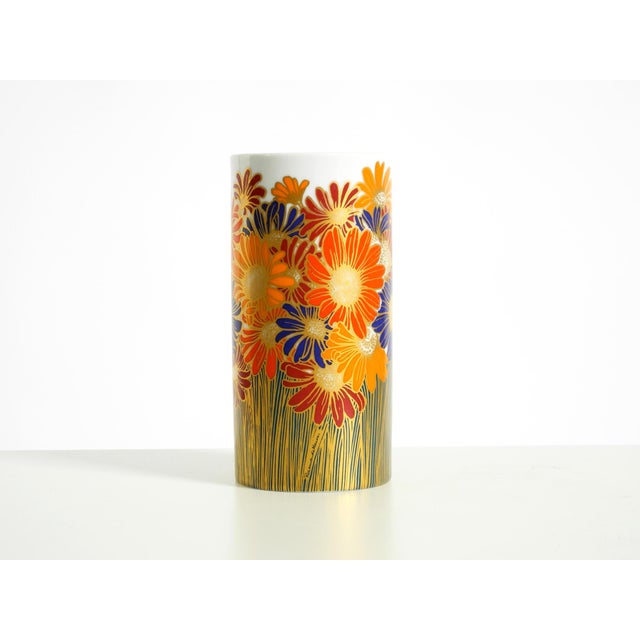 Beautiful white porcelain vase featuring typical colorful floral and daisy motifs from the 1980s. Designed by Rosemonde...