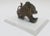 A highly expressive vintage African cast-bronze sculpture depicting a stylized mythical lion, attributed broadly to a West...