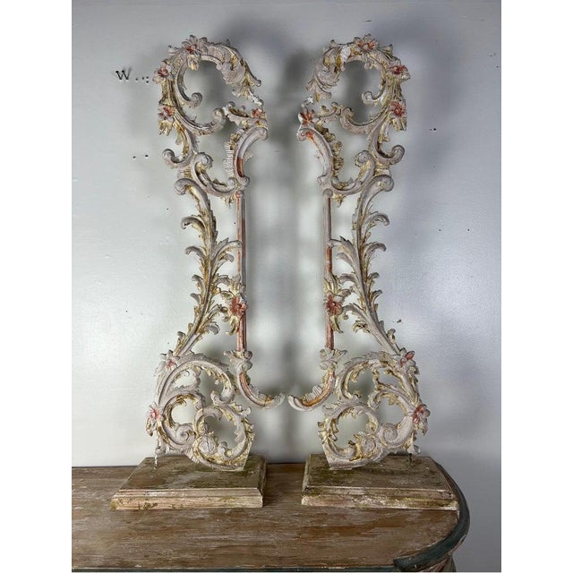 A pair of 19th-century carved Italian architectural elements mounted on wood bases. The Rococo style carvings showcase...