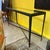 Steel and beveled glass top industrial and brutalist console table with bottom x- frame stretcher. Industrial in design...