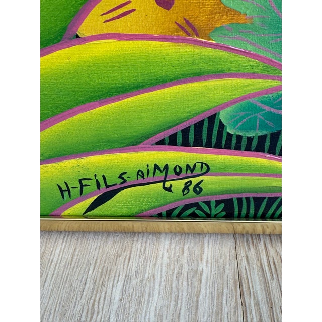 Vibrant and highly decorative Haitian naïve (folk art) jungle painting by Henri Filsaimond, signed and dated 1986. This...