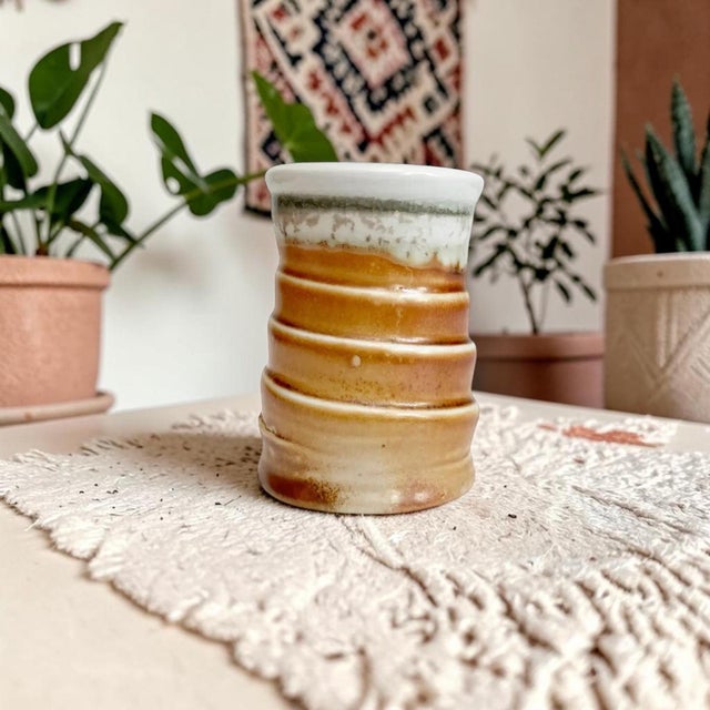 Elevate your home decor with our Artisan Stamped Wheel Thrown Pottery Bud Vase, featuring a unique textured spiral design...
