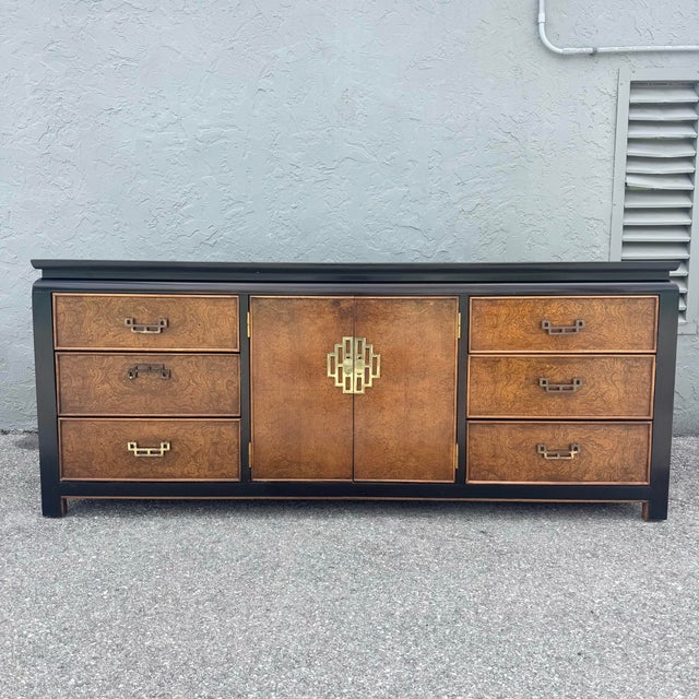 A striking Mid Century Chinoiserie dresser by Century Furniture, showcasing the richness of burlwood grain framed by a...