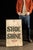 This vintage sign advertises for shoe shining service and would have been prominently displayed on a sidewalk. The sign is...