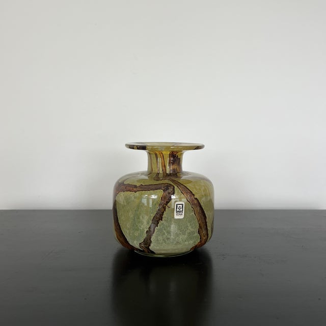 A rare and highly collectable bud vase by Mdina glassware, established in 1968 in Malta by Michael Harris, a lecturer in...