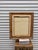 This vintage framed oil painting is signed "Mary Botto" and depicts a charming European village street scene with old-...