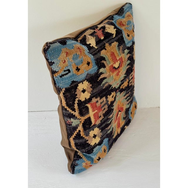 A vintage Turkish kilim custom made into a pillow. The interior with newer synthetic cushion.