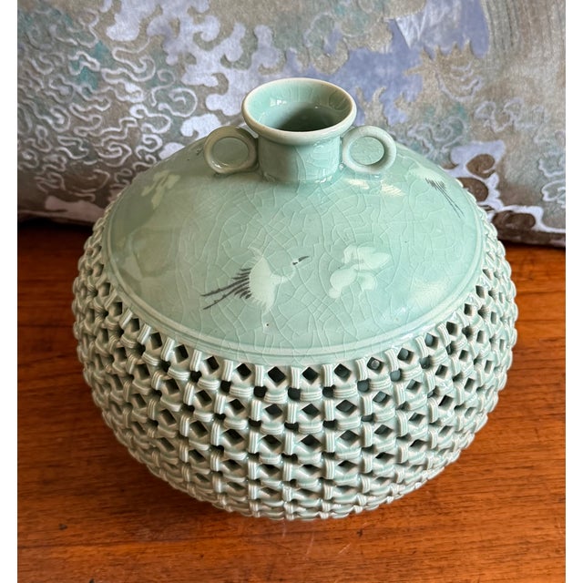 A celadon crackleware glaze, with cranes and clouds on the shoulder of the vase, with exquisite latticework surrounding...