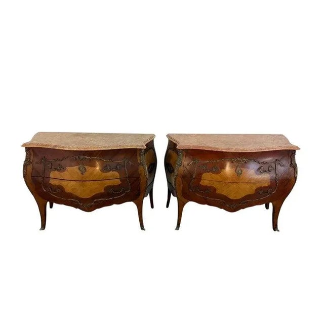 A fine pair of Spanish bombe-form chests, each surmounted with a shaped Portuguese marble top. The richly veined marble...