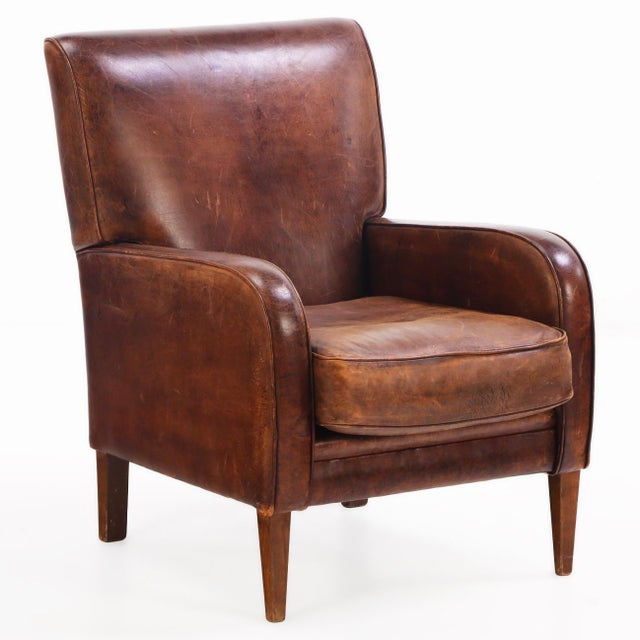 This warm chocolate brown chair is in very good condition and sits well with squared crest, slightly rolled arms and a...