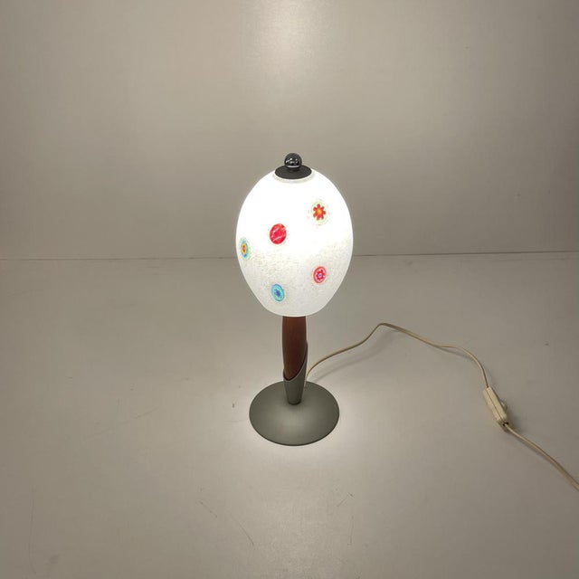 Italian cute table lamp with a murine encrusted Murano glass lamp shade above a wood and metal Tekna base from the 1990s....