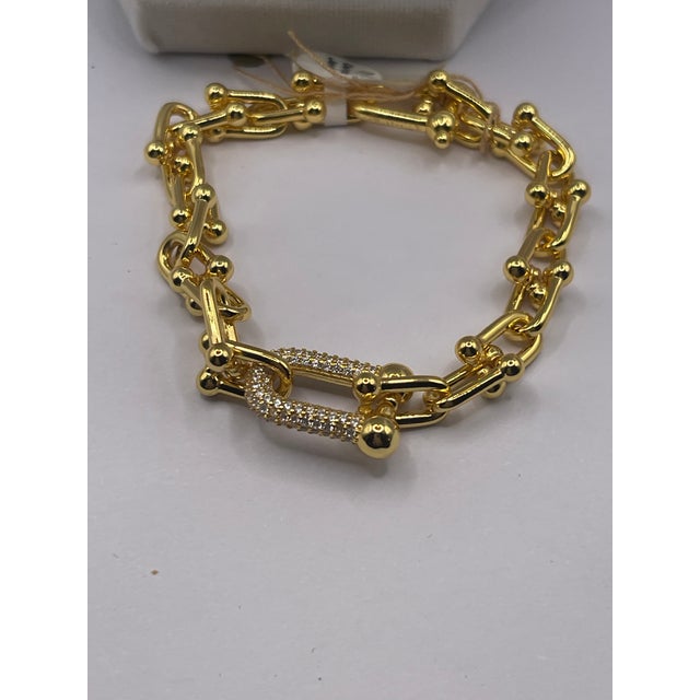 small link gold braclet with cz closure.famous name with matching earings 3" long