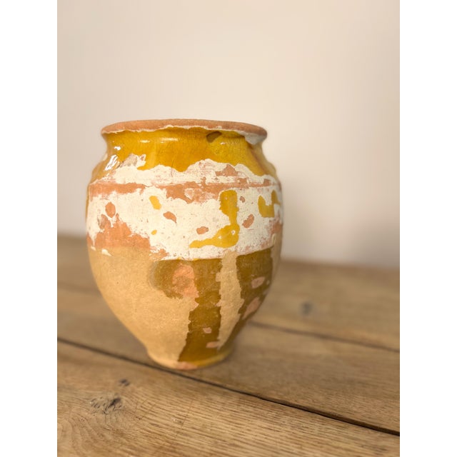 Antique golden yellow glazed terra cotta confit pots from Southwest France. These 19th century vessels once preserved...