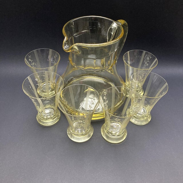 Art Deco yellow blown glass drinking set: jug and 6 hand decorated glasses. Jug: height 7.09", diameter 4.33". Glasses:...