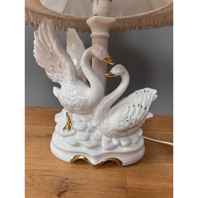An elegant salon table lamp signed CL Italy, crafted from fine white porcelain. The decorative base features a graceful...