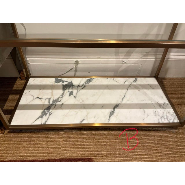 Stylish Revelation Floating Plane Etagere. Brass frame, marble bottom. Glass shelves. Original Retail $6465. Showroom...