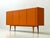 An exceptionally striking, large-format sideboard from the 1960s in a vibrant orange. The clean, strictly structured front...