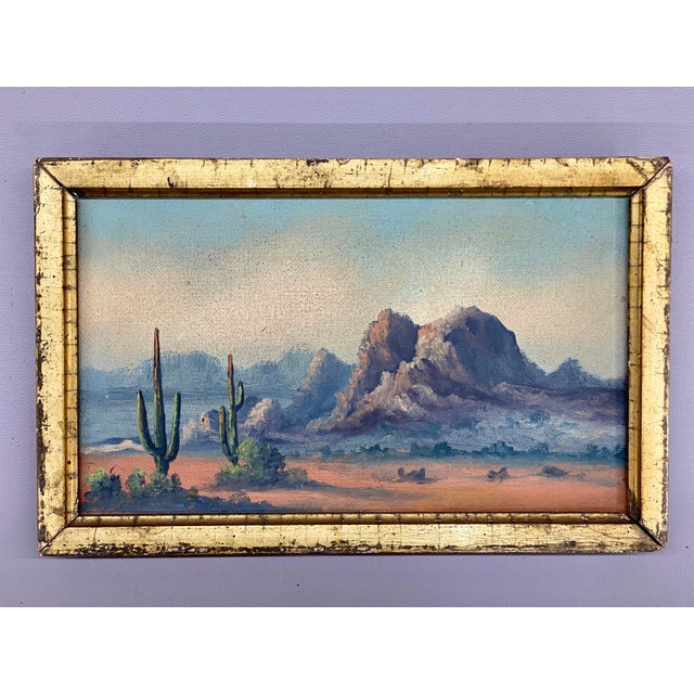 A nice rendering of Southwestern desert scene including Saguaro cacti, pink sands and mountains in the background. Circa...