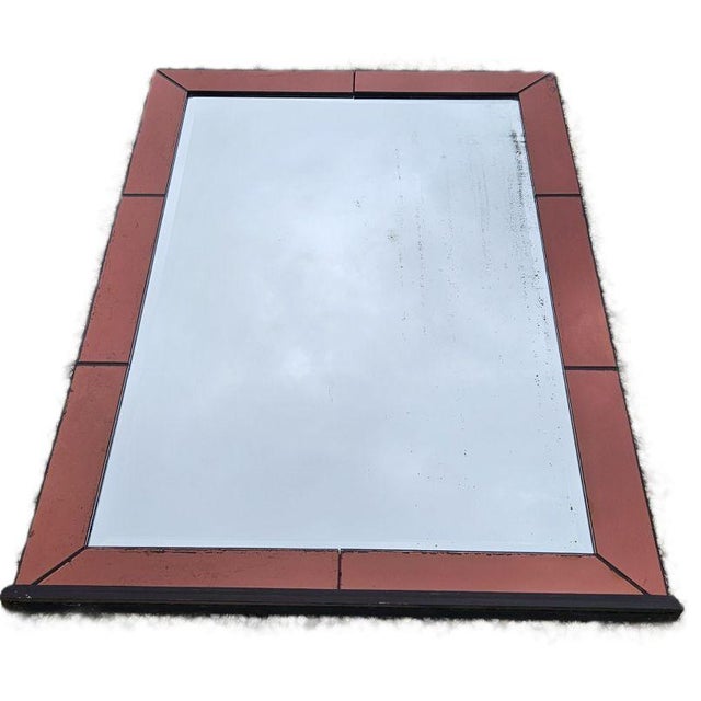 Original amber-colored glass mirror with glazing beads in the style of Jacque Adnet. The glass is beveled and shows signs...